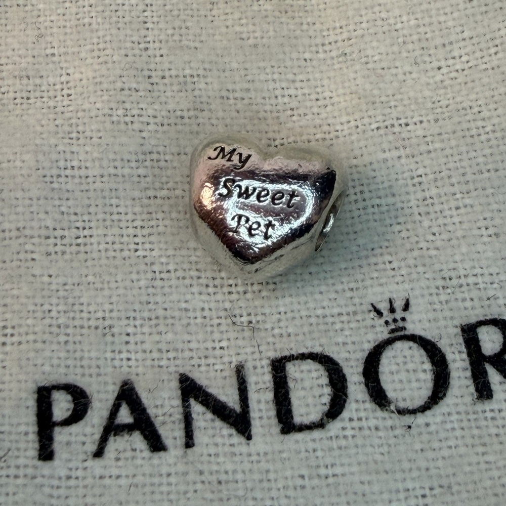 RETIRED Pandora “My Sweet Pet” sterling silver charm.